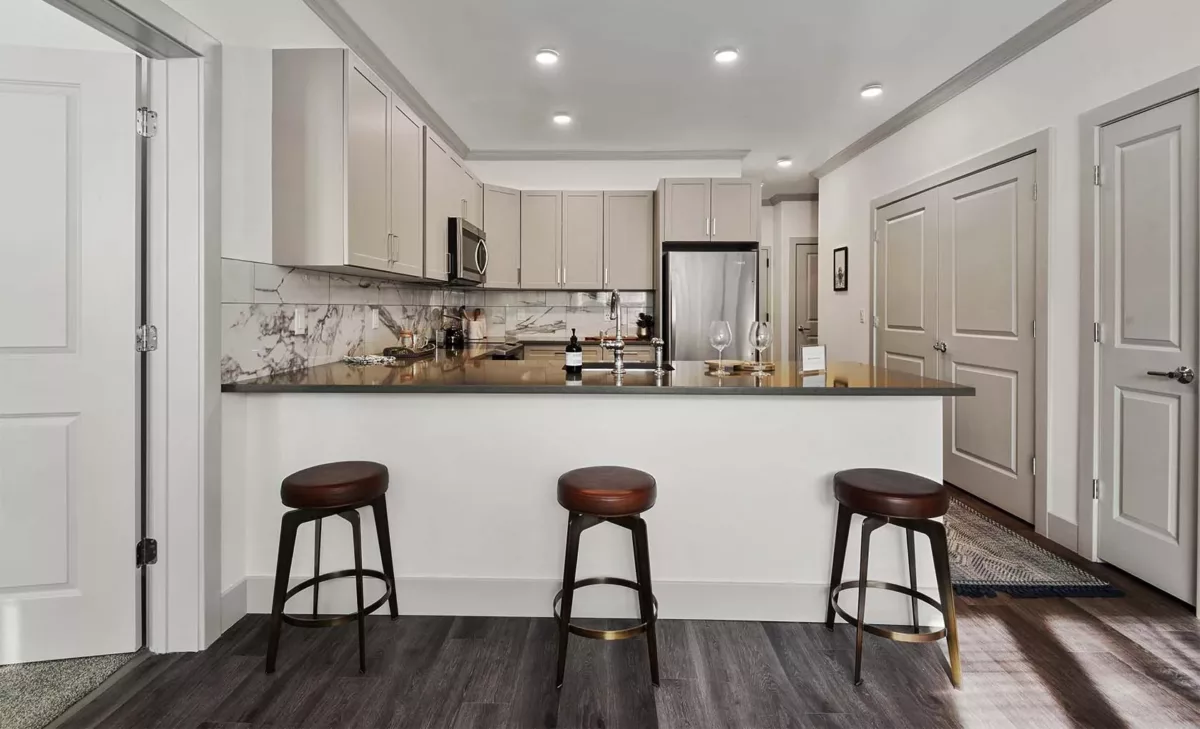Contemporary kitchen featuring stainless steel appliances and quarter countertops.